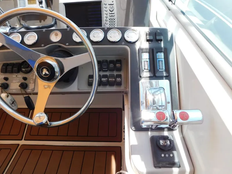 Slide: The Image of 1999 Formula 41 Performance Cruiser helm with steering wheel and control panel. - 15