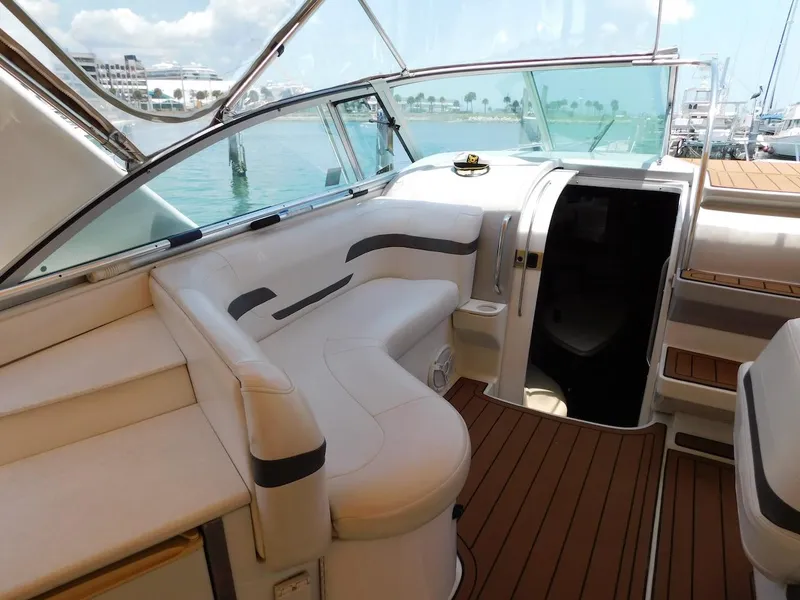 Slide: The Image of 1999 Formula 41 Performance Cruiser interior with white seating and wood flooring. - 20