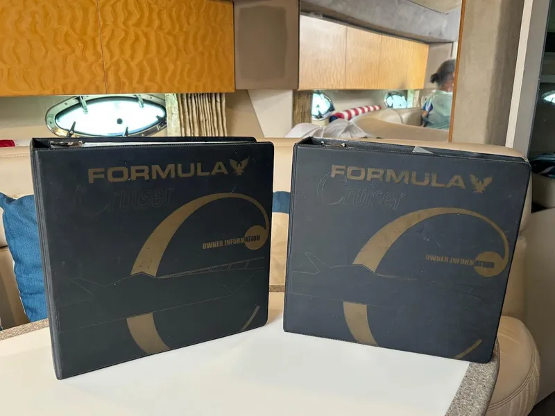 Slide: The Image of Two black binders labeled Formula Cruiser inside a 1999 Formula 41 Performance Cruiser. - 24