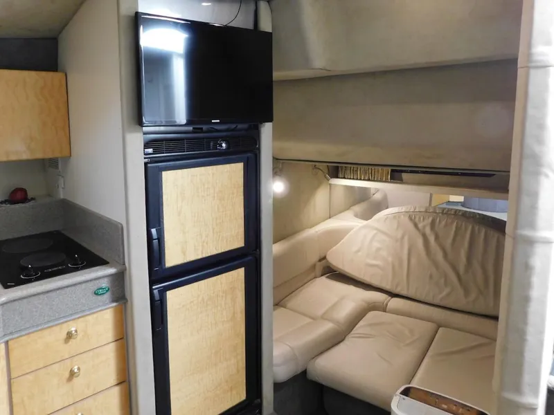 Slide: The Image of Interior of 1999 Formula 41 Performance Cruiser with kitchenette, fridge, TV, and seating area. - 32