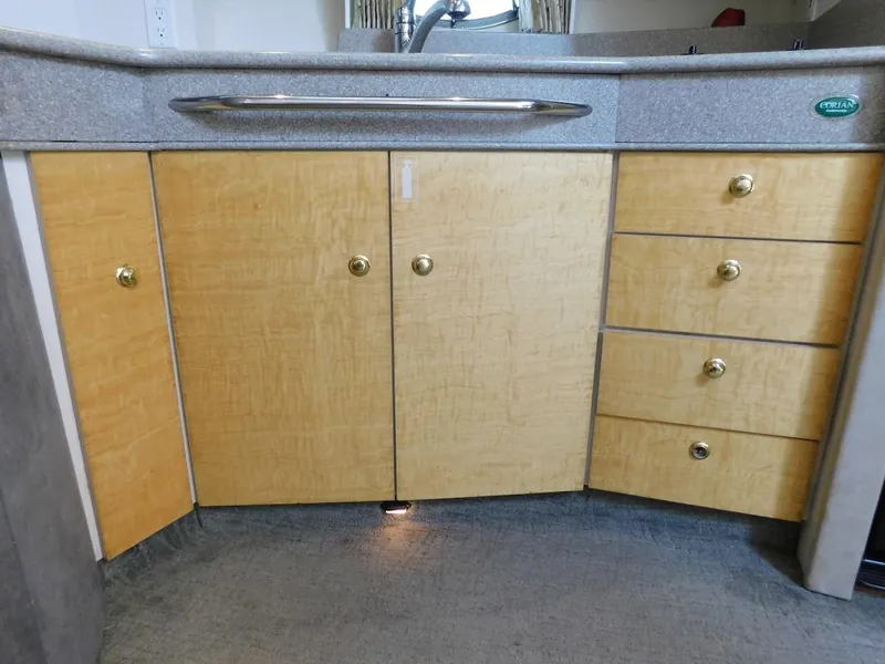 Slide: The Image of 1999 Formula 41 Performance Cruiser wooden cabinet and drawers in the kitchen area. - 35