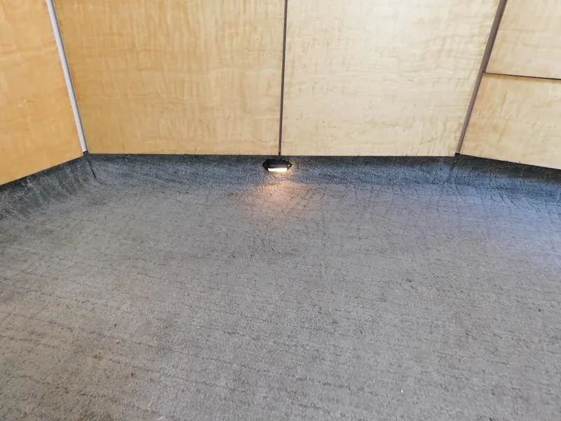 Slide: The Image of 1999 Formula 41 Performance Cruiser interior with carpeted flooring and wooden paneling. - 36