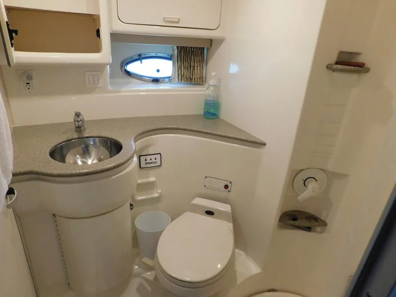 Slide: The Image of 1999 Formula 41 Performance Cruiser bathroom with sink, toilet, and storage cabinets. - 39