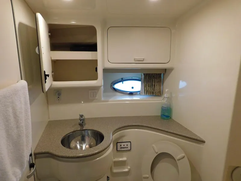Slide: The Image of 1999 Formula 41 Performance Cruiser bathroom with sink, storage, and porthole window. - 40