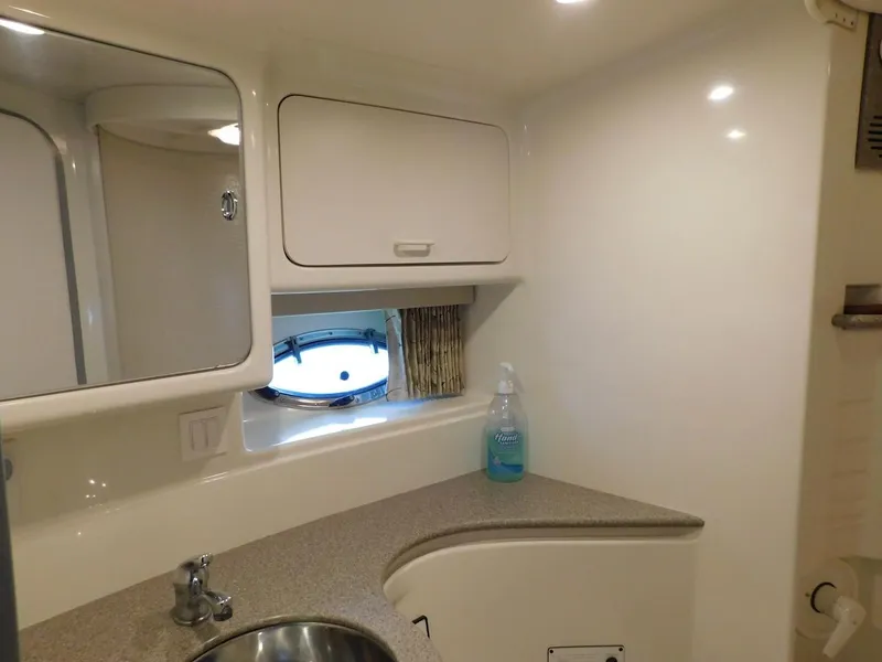 Slide: The Image of 1999 Formula 41 Performance Cruiser bathroom with sink, mirror, and storage cabinets. - 42