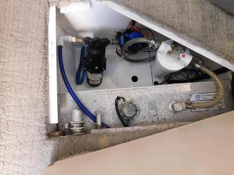 Slide: The Image of 1999 Formula 41 Performance Cruiser engine compartment with water pump and hoses. - 44