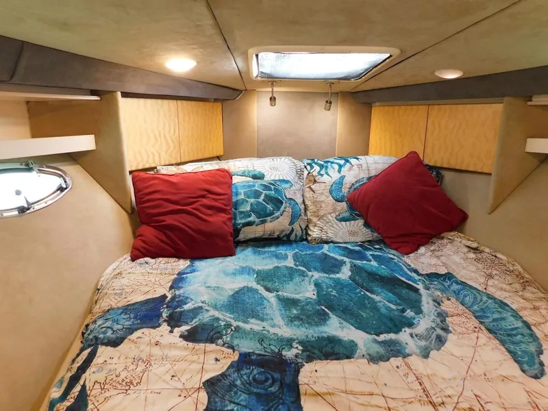 Slide: The Image of 1999 Formula 41 Performance Cruiser cabin with turtle-themed bedding and red pillows. - 45