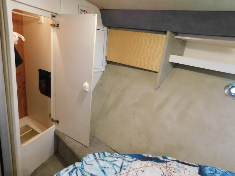 Slide: The Image of 1999 Formula 41 Performance Cruiser cabin interior with open closet and bed. - 47
