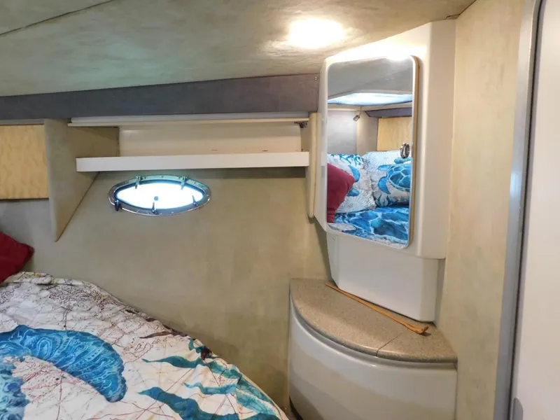 Slide: The Image of 1999 Formula 41 Performance Cruiser cabin interior with bed, mirror, and porthole. - 48