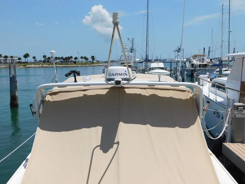 Slide: The Image of 1999 Formula 41 Performance Cruiser docked at a marina with Garmin equipment. - 6