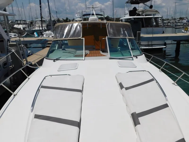 Slide: The Image of 1999 Formula 41 Performance Cruiser docked at a marina with sun pads on the bow. - 9