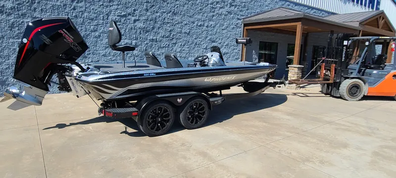 Slide: The Image of 2025 Phoenix 920 Elite 1 boat on trailer outside a building. - 8