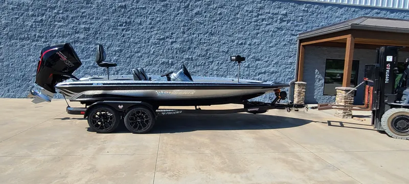 The Image of 2025 Phoenix 920 Elite 1 boat on a trailer outside a building. - 0