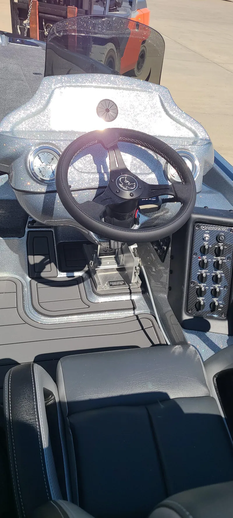 Slide: The Image of 2025 Phoenix 920 Elite 1 boat dashboard and steering wheel - 2