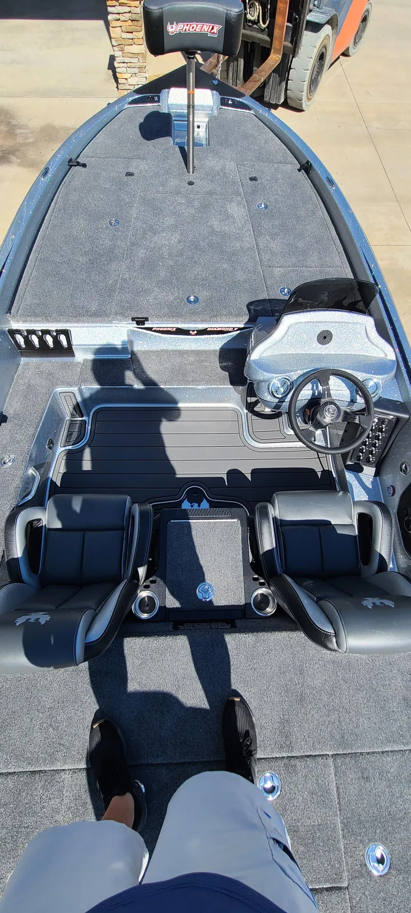 Slide: The Image of 2025 Phoenix 920 Elite 1 boat interior with steering wheel and seating. - 3