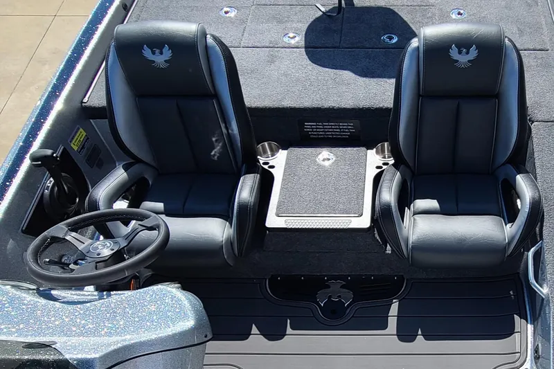 Slide: The Image of Phoenix 920 Elite 1 2025 boat interior with dual black seats and steering wheel. - 4
