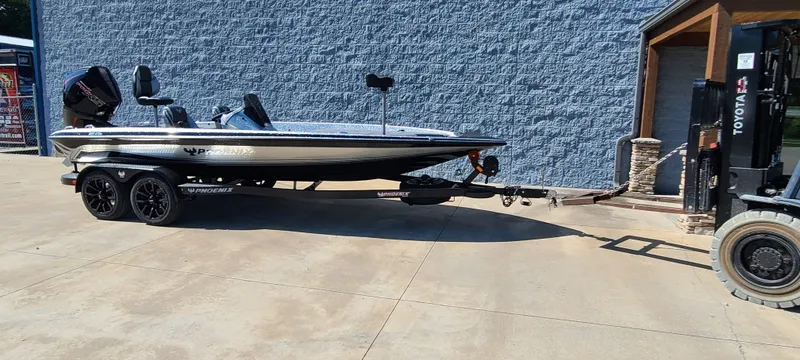 Slide: The Image of 2025 Phoenix 920 Elite 1 boat on trailer being moved by a forklift. - 7
