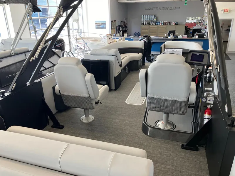 Slide: The Image of 2024 Crest Caribbean 230 SLS RS boat interior with modern seating and helm. - 10