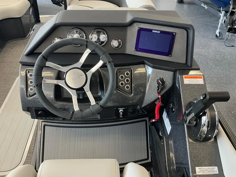 Slide: The Image of 2024 Crest Caribbean 230 SLS RS boat dashboard with steering wheel and control panel. - 11