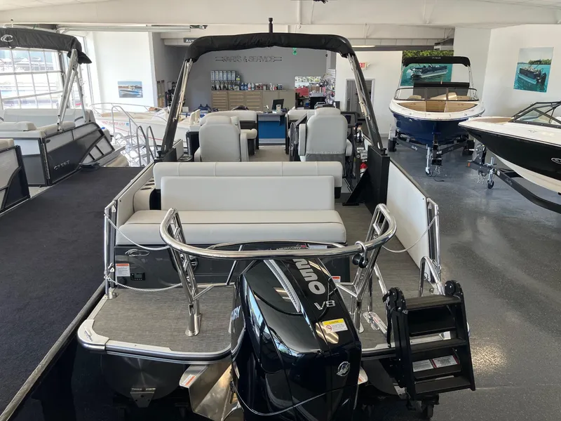 Slide: The Image of 2024 Crest Caribbean 230 SLS RS pontoon boat with Mercury V8 engine in showroom. - 8