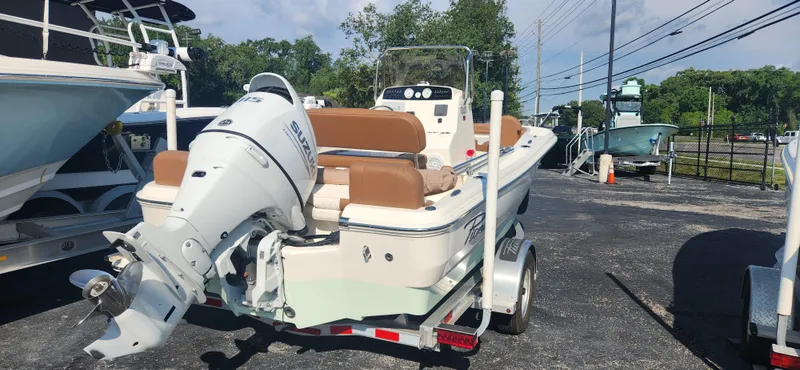 Slide: The Image of 2022 Pioneer 180 Islander boat on trailer with outboard motor in parking lot. - 3