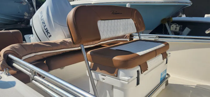 Slide: The Image of 2022 Pioneer 180 Islander boat with brown and white cushioned seating. - 5