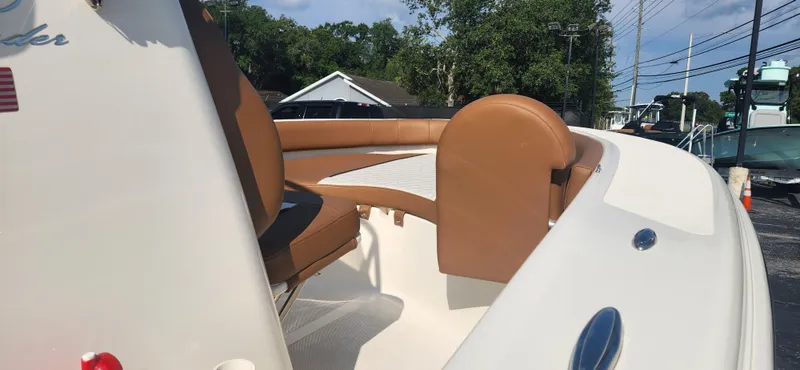 Slide: The Image of 2022 Pioneer 180 Islander boat with tan seating and white deck. - 8
