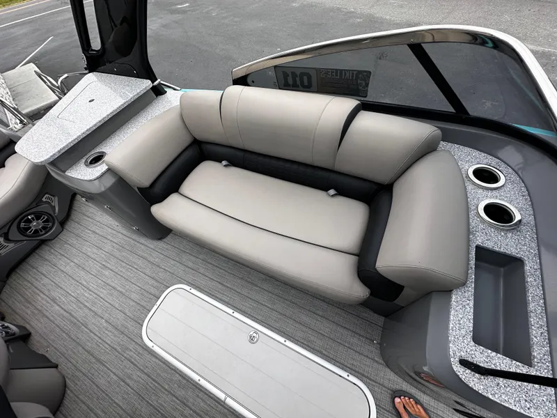 Slide: The Image of Luxurious seating on 2021 Avalon Excalibur 2585 Windshield Elite boat, featuring modern design and cup holders. - 18