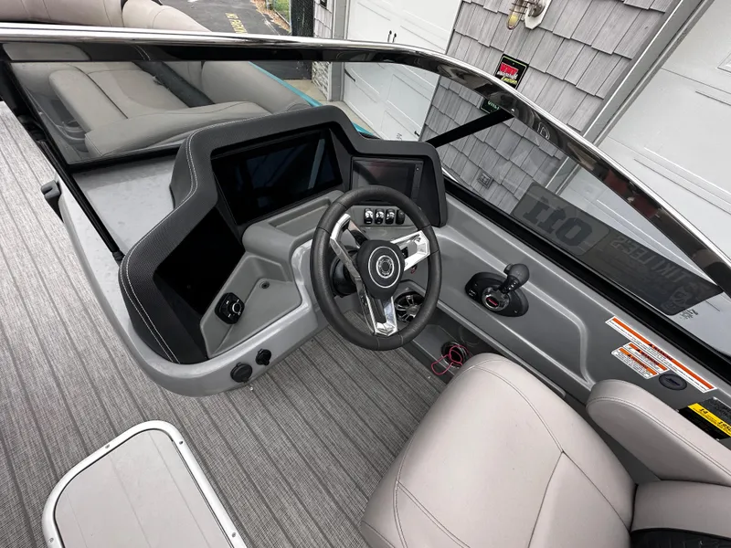 Slide: The Image of 2021 Avalon Excalibur 2585 boat interior with modern dashboard and steering wheel. - 20