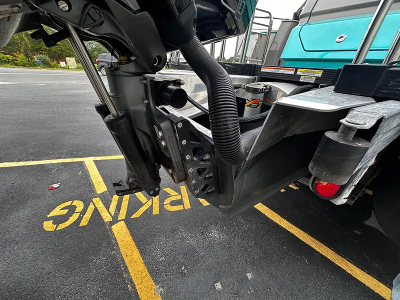 Slide: The Image of 2021 Avalon Excalibur 2585 boat engine detail in parking lot. - 7