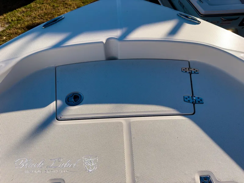 Slide: The Image of 2024 Pathfinder TRS 2200 boat deck with storage compartment and textured surface. - 11