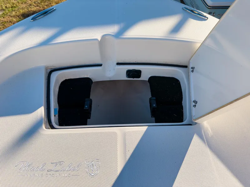 Slide: The Image of 2024 Pathfinder TRS 2200 boat storage compartment with open hatch, showcasing interior space. - 12