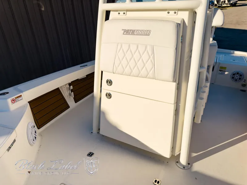 Slide: The Image of 2024 Pathfinder TRS 2200 boat interior with white seating and storage compartments. - 13
