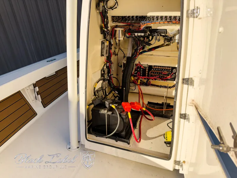 Slide: The Image of 2024 Pathfinder TRS 2200 boat electrical compartment with wiring and battery setup. - 14