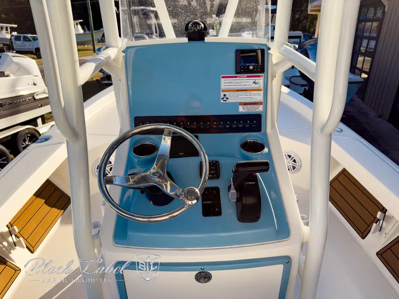 Slide: The Image of 2024 Pathfinder TRS 2200 boat console with steering wheel and controls. - 18