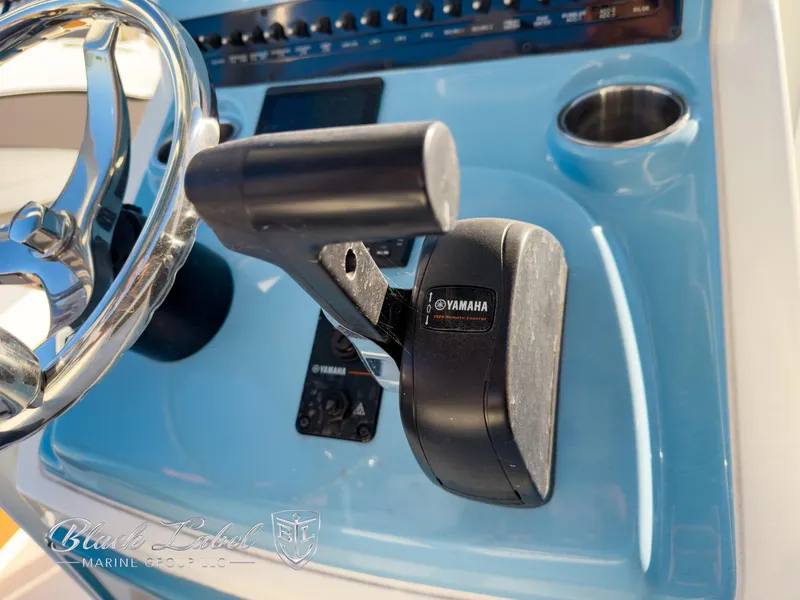 Slide: The Image of 2024 Pathfinder TRS 2200 boat console with Yamaha throttle control and steering wheel. - 24
