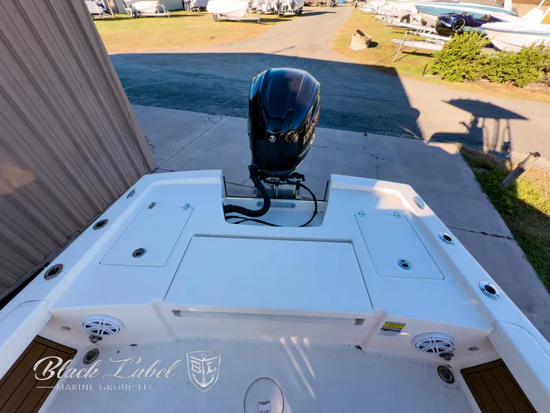 Slide: The Image of 2024 Pathfinder TRS 2200 boat with outboard motor, docked at marina. - 27