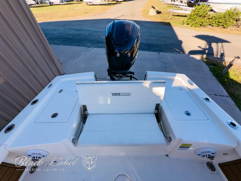 Slide: The Image of 2024 Pathfinder TRS 2200 boat with outboard motor, docked in a sunny marina. - 28