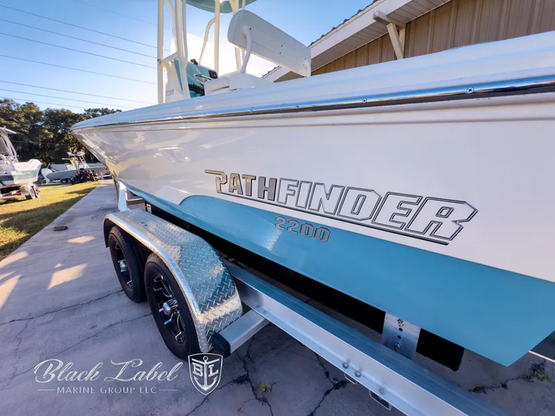 Slide: The Image of 2024 Pathfinder TRS 2200 boat on trailer, side view, Black Label Marine Group logo. - 3