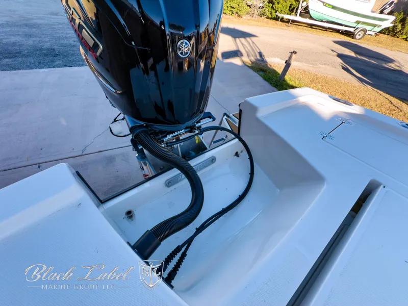 Slide: The Image of 2024 Pathfinder TRS 2200 boat with Yamaha outboard motor, docked on a sunny day. - 30