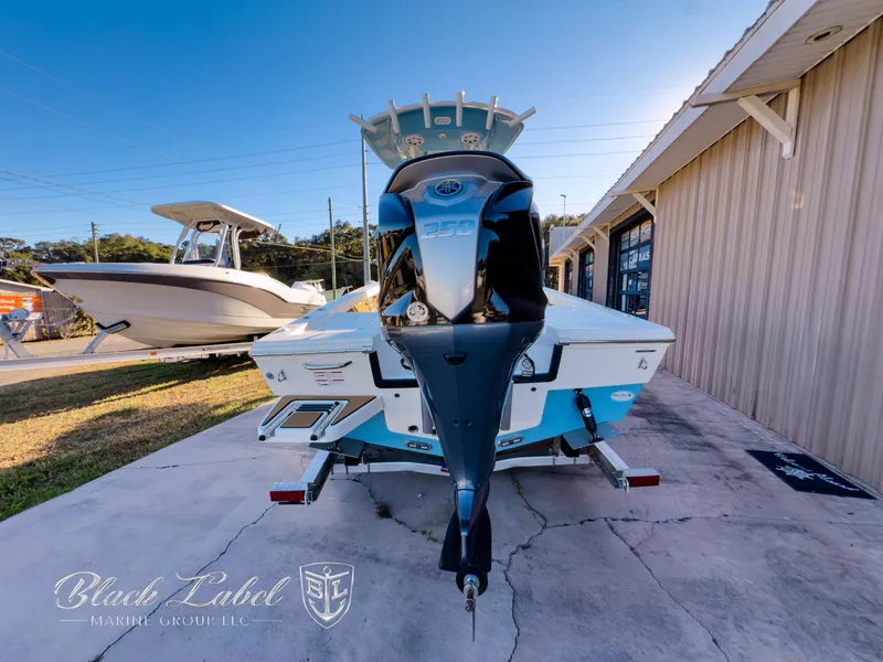 Slide: The Image of 2024 Pathfinder TRS 2200 boat on trailer, displayed outdoors near a building. - 4