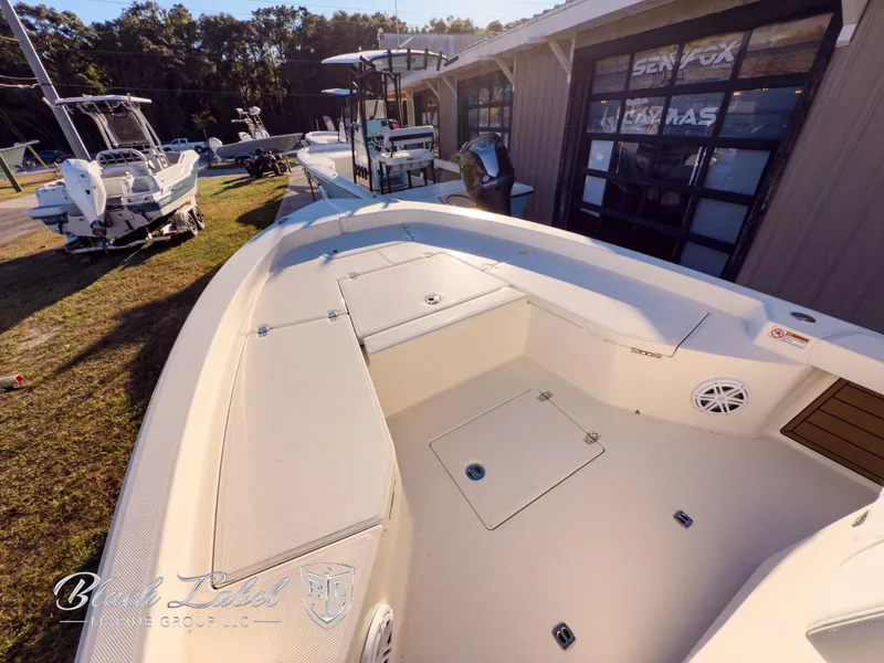 Slide: The Image of 2024 Pathfinder TRS 2200 boat on display outdoors, showcasing spacious deck and storage compartments. - 7
