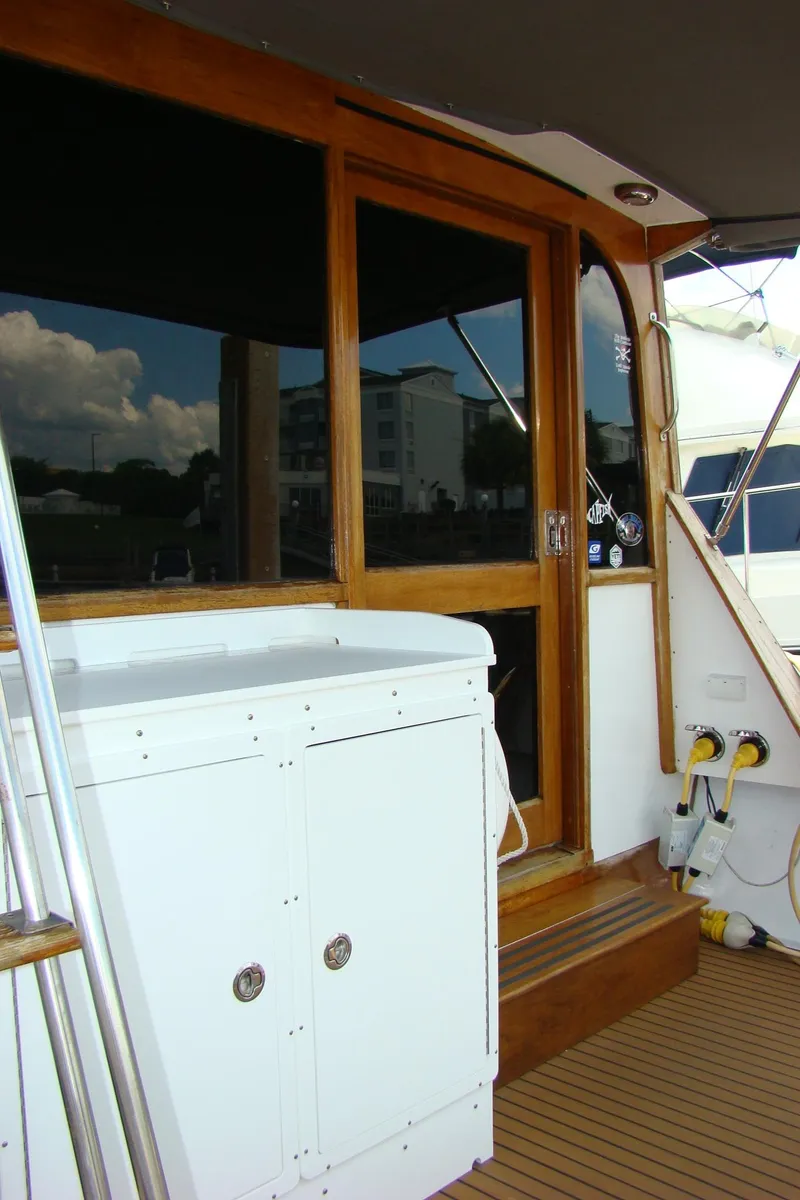 Slide: The Image of 1985 Jersey Dawn 40 yacht with wooden trim and white cabinetry. - 13