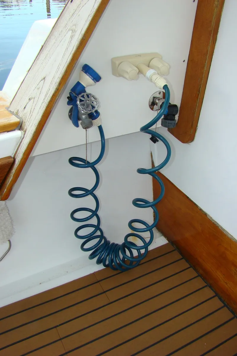 Slide: The Image of Coiled blue hose on 1985 Jersey Dawn 40 boat deck. - 17