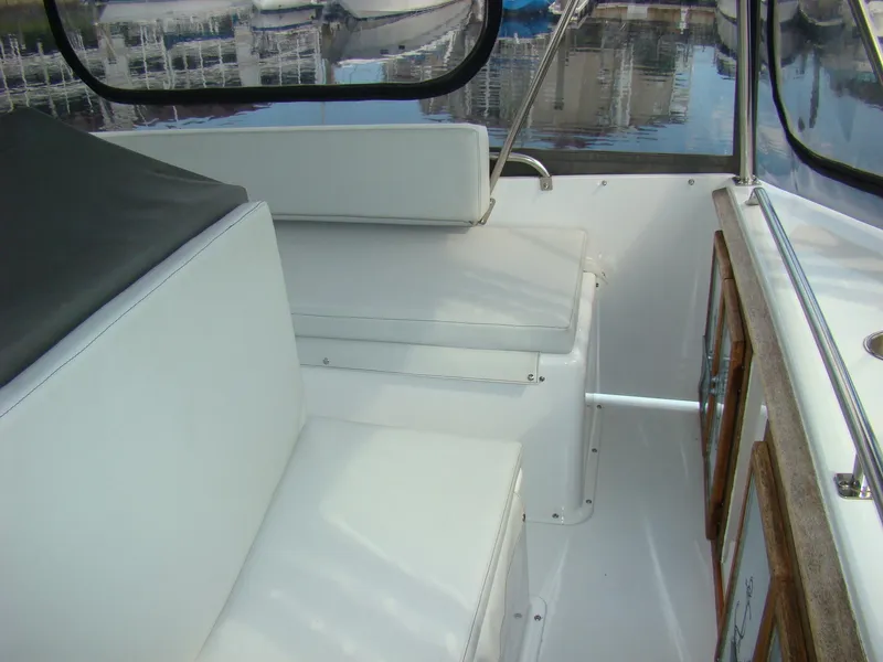 Slide: The Image of Interior seating of 1985 Jersey Dawn 40 boat with white cushions. - 29