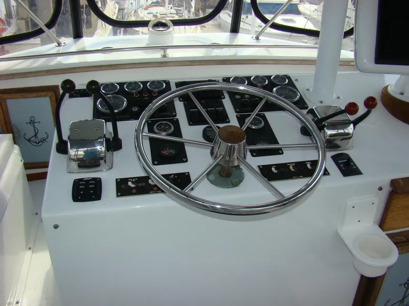 Slide: The Image of 1985 Jersey Dawn 40 boat helm with steering wheel and control panel. - 31