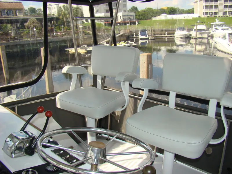 Slide: The Image of Interior of 1985 Jersey Dawn 40 boat with helm, steering wheel, and two white captain chairs. - 33
