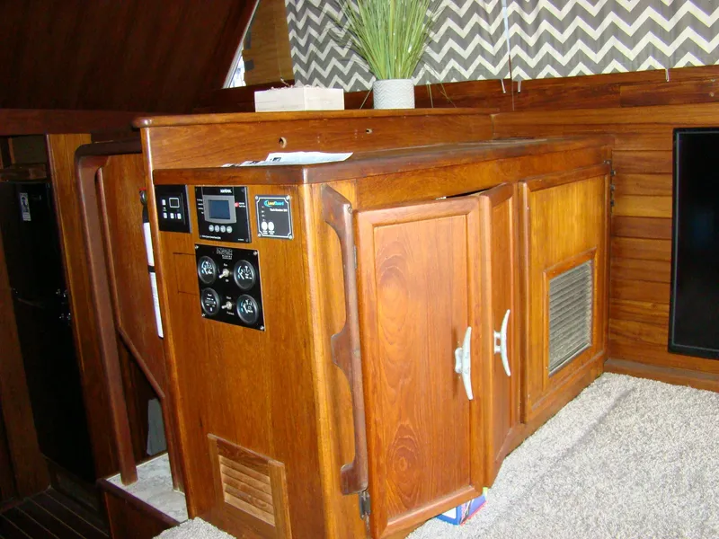 Slide: The Image of Control panel and wooden cabinetry inside a 1985 Jersey Dawn 40 boat. - 45