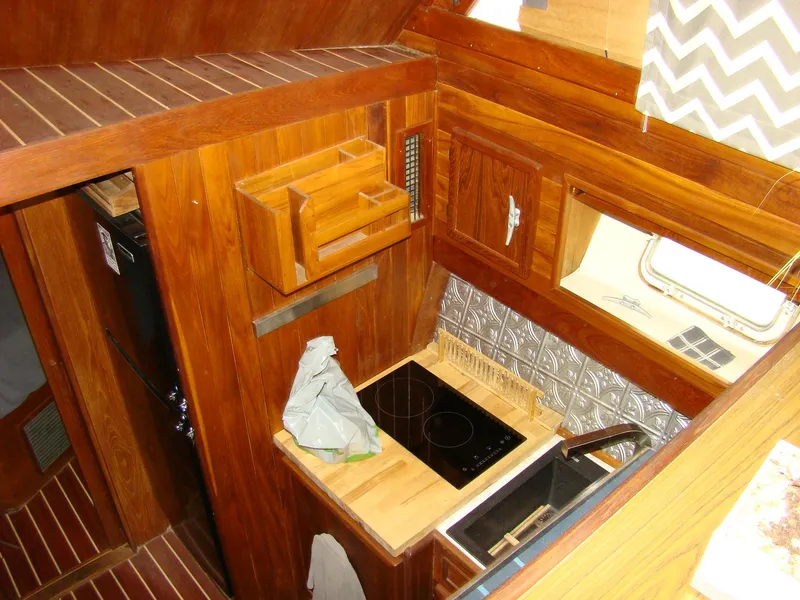 Slide: The Image of 1985 Jersey Dawn 40 boat kitchen with wooden cabinetry and electric stove. - 46
