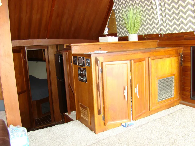 Slide: The Image of Interior of 1985 Jersey Dawn 40 boat with wooden cabinetry and cozy cabin. - 47